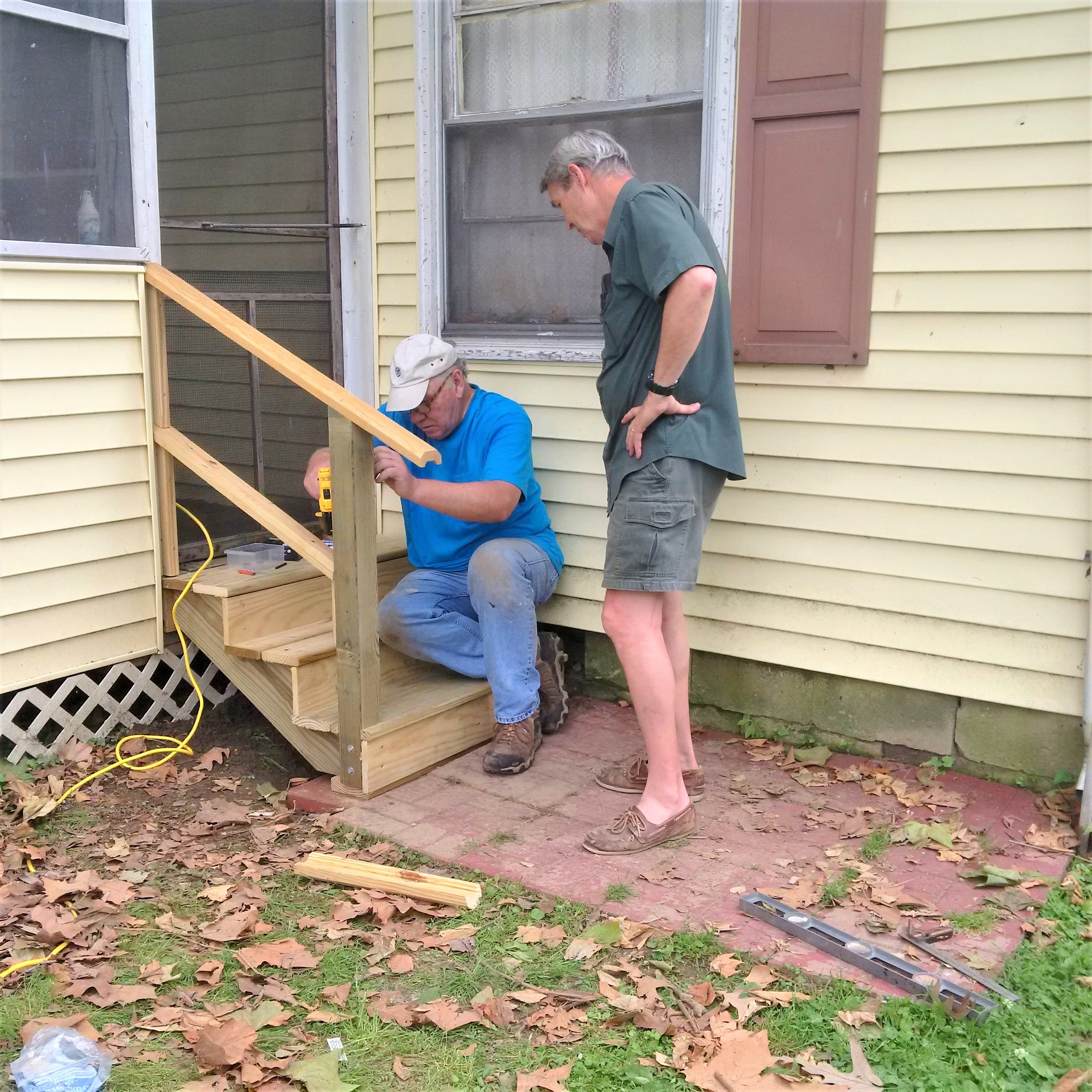 Two men building wooden steps